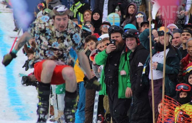 Crowds gathered for the slush cup, which saw skiers and snowboarders try and leap over a pool of water as part of the first Snowbombing event in Sun Peaks, April 8, 2017.