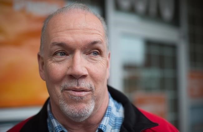 FILE PHOTO - British Columbia NDP Leader John Horgan speaks to a reporter after unveiling his election campaign bus in Burnaby, B.C., on Tuesday April 4, 2017.