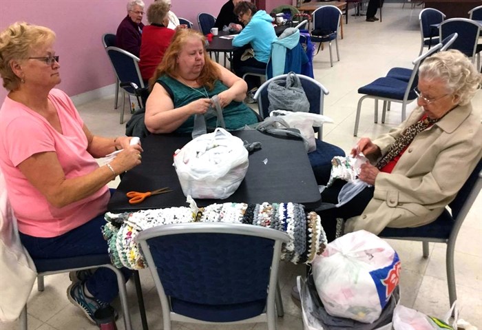 Women at the Centre for Seniors Information learning to crochet sleeping mats out of grocery bags on April 27, 2017.