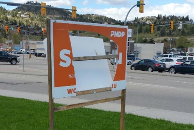 Both sides of a large campaign sign were cut by a vandal last week.