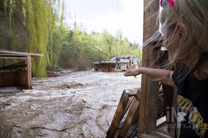 Water has completely surrounded Corine LeBourdais' tack shop on her Cherry Creek property. 