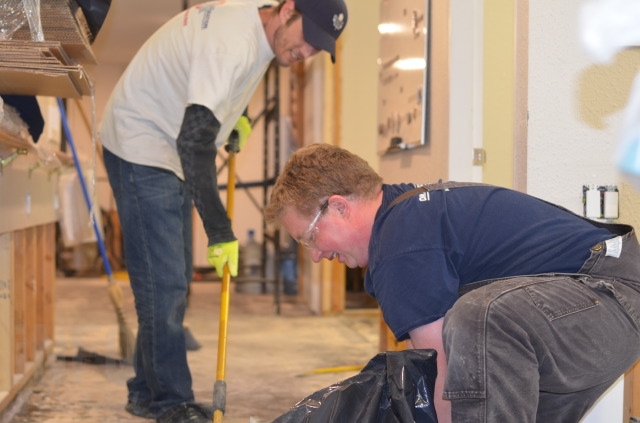 Steven Trevis and Kyle Vriesinga of Okanagan Restoration rip up flooring at the Bechtold Centre in Armstrong. 