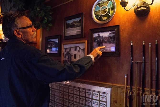 Jeff Kirkham describes the photographs of the pub over the years, all of which are hanging up across from the billiards table.