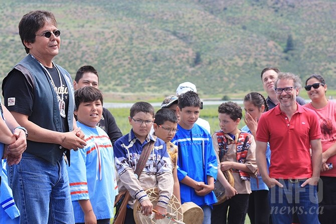 Osoyoos Indian Band Chief Clarence Louis (left)  pays homage to Canadian Formula One racer Jacques Villeneuve (second from right)  at the opening ceremonies of Area 27 east of Osoyoos, June 3, 2017.