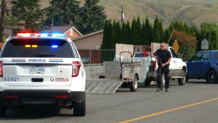 A heavily armed RCMP officer can be seen as police respond to a firearms complaint in the Brocklehurst neighbourhood in Kamloops, Tuesday, June 6, 2017.