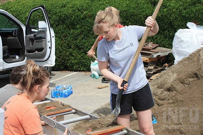Pen-High students Kim Steur and Hannah Guenther fill sandbags at Red Wing Resort.