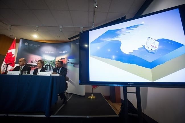 Animation of the capsizing of the whale-watching vessel Leviathan II off Vancouver Island in 2015 is played as Transportation Safety Board Manager of Marine Investigations Pierre Murray, from left to right, Chair Kathy Fox, and Investigator-in-Charge Clinton Rebeiro, watch during a news conference to release recommendations and findings of their investigation, in Vancouver, B.C., on Wednesday June 14, 2017. 