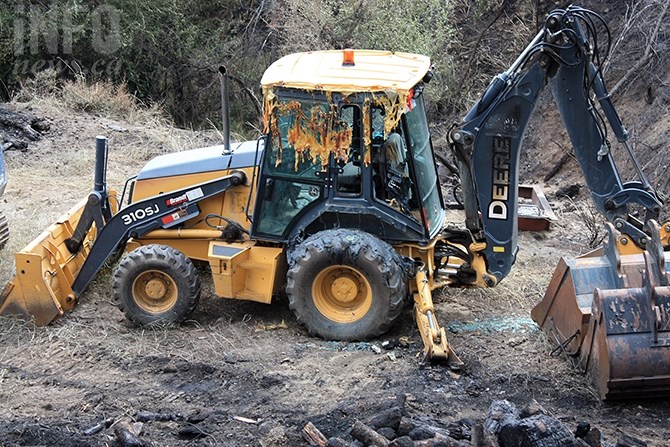 Larry Richardson's loader cab melted from the heat of the wildfire, but he still managed to move the equipment to safety.