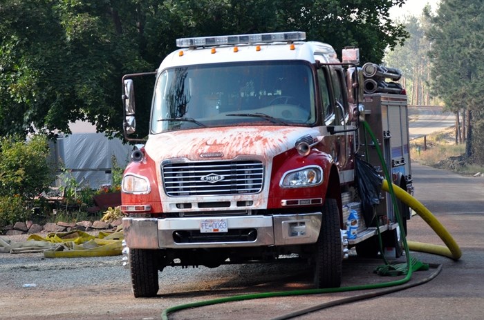 A fire truck is covered with fire retardant.