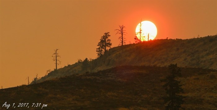 The sun is red due to the smoke cover.