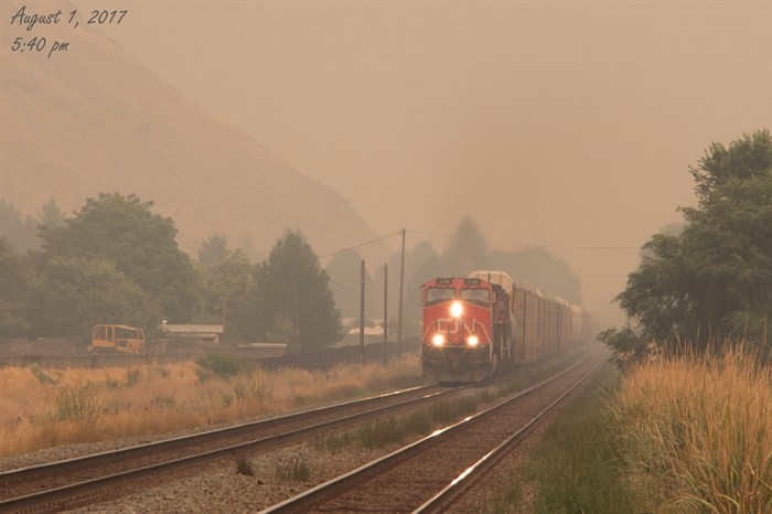 Train coming through the smoke.