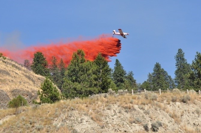 Air support was brought in from Kamloops to help knock down a grass fire police say was started deliberately on Knox Mountain July 30, 2017.