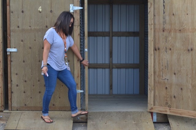 Lisa Anderson, co-executive director of the Upper Room Mission, opens up a storage shed. 