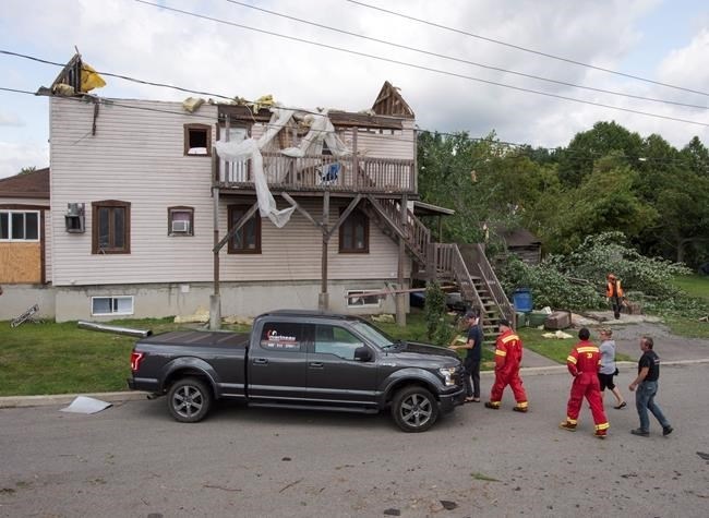 Residents survey the damage from a category one tornado, Wednesday, August 23, 2017 in Lachute, Que., northwest of Montreal.