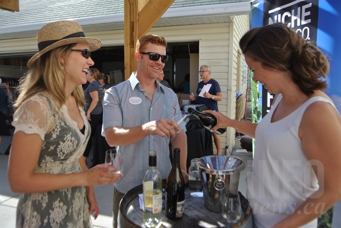 Renee Stewart and her husband Chris Stewart try some of Niche Wine Company's wine, at the Garagiste North festival Sunday afternoon, Aug. 27, 2017.