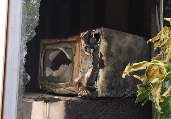 The couple's home nearly burned down when someone broke into the home and started the microwave with metal inside. 
