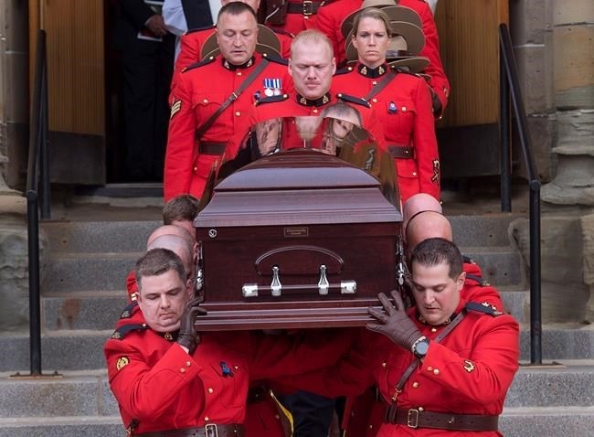 Pallbearers carry the coffin at the regimental funeral for RCMP Const. Francis Deschenes at St. Bernard's Catholic Church in Moncton, N.B. on Wednesday, Sept. 20, 2017. Deschenes was killed after he stopped to help a motorist change a tire and a cargo van slammed into his cruiser. 