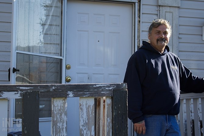 Bill McGinn stands outside of his home where his son Shane Caron was involved with a standoff with RCMP.