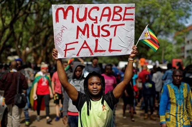 Protesters demanding President Robert Mugabe stands down march towards State House in Harare, Zimbabwe Saturday, Nov. 18, 2017.