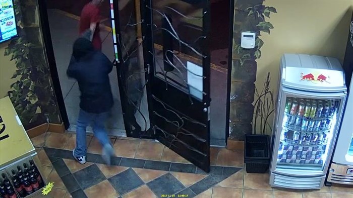 Video surveillance footage shows an armed robbery suspect chasing as employee out of Toro's Cold Beer and Wine store on Kalamalka Lake Road in Vernon, Friday, Nov. 24, 2017.