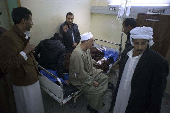 Relatives of Sheikh Sulieman Ghanem, 75, center, surround him as he receives medical treatment at Suez Canal University hospital in Ismailia, Egypt, Friday, Nov. 24, 2017, after he was injured during an attack on a mosque.