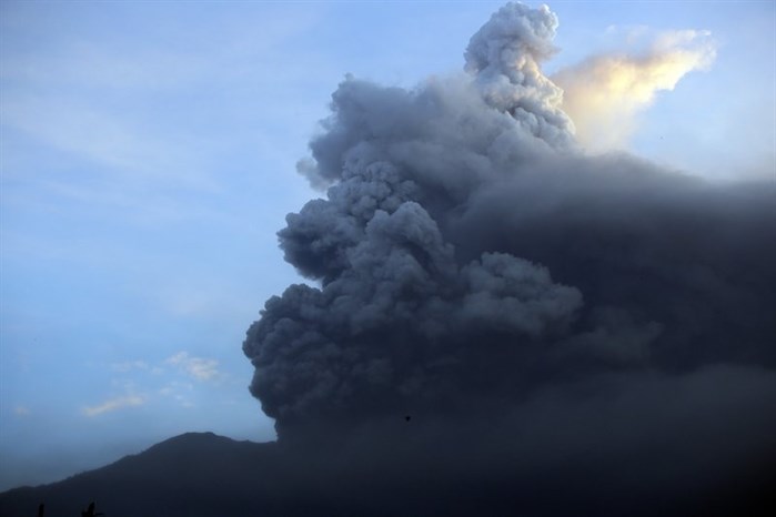 A view of the Mount Agung volcano erupting at sunrise in Karangasem, Bali island, Indonesia, Sunday, Nov. 26, 2017.