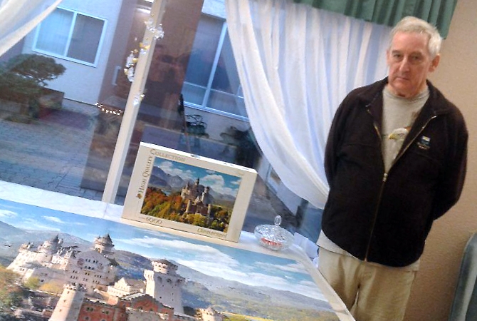 Robert Miles and 5,999 pieces of a 6,000-piece jigsaw puzzle he put together over the last 14 months.