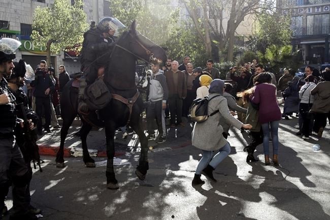 Israeli horse mounted police charges Palestinians during a protest against U.S. President Donald Trump's decision to recognize Jerusalem as the capital of Israel in Jerusalem, Saturday, Dec.9, 2017.