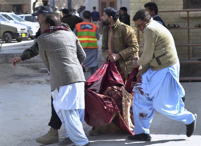 A paramilitary soldier and volunteers rescue an injured women following a suicide attack on a church in Quetta, Pakistan, Sunday, Dec. 17, 2017.
