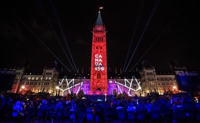 A Canada 150 projection is seen on Parliament Hill's Centre Block's at the conclusion of the illumination launch ceremony of Christmas Lights Across Canada, in Ottawa on Thursday, Dec. 7, 2017. 