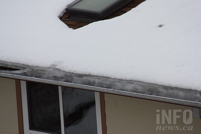 Melting snow forms an ice dam on an Okanagan roof. The problem is more prevalent in the region this year as cold temperatures and heavy snow set up the condition, made worse by moderating temperatures this week.