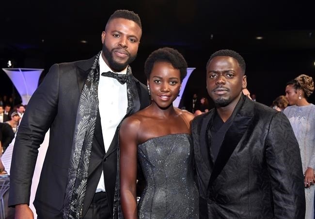Winston Duke, from left, Lupita Nyong'o and Daniel Kaluuya pose in the audience at the 24th annual Screen Actors Guild Awards at the Shrine Auditorium & Expo Hall on Sunday, Jan. 21, 2018, in Los Angeles.