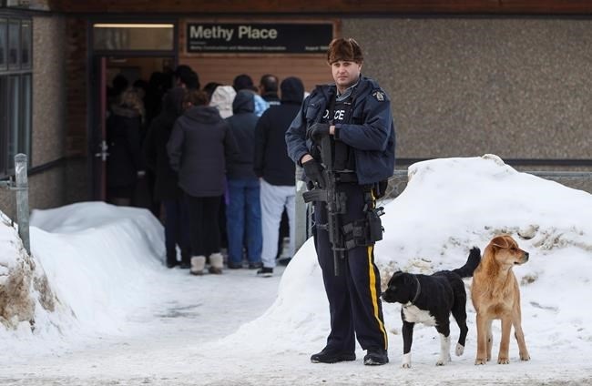 Police stand guard outside court as a provincial court judge decides if a teen who pleaded guilty in the 2016 shooting spree that left four people dead and seven others wounded will be sentenced as an adult in La Loche, Sask. on Friday, February 23, 2018.