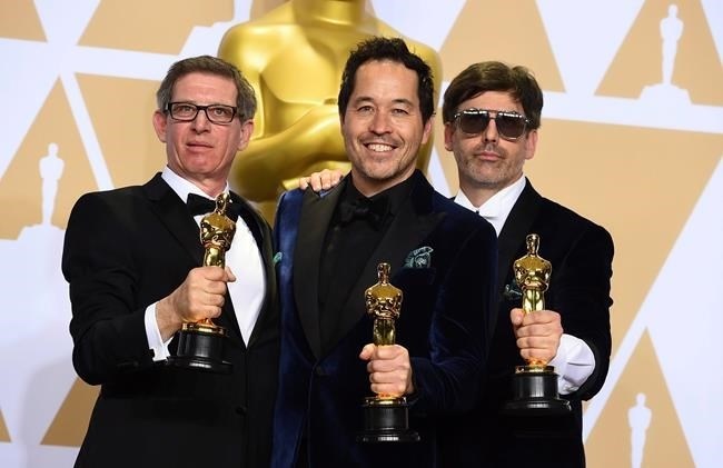 Jeffrey A Melvin, from left, Paul D. Austerberry, and Shane Vieau, winners of the award for best production design for 