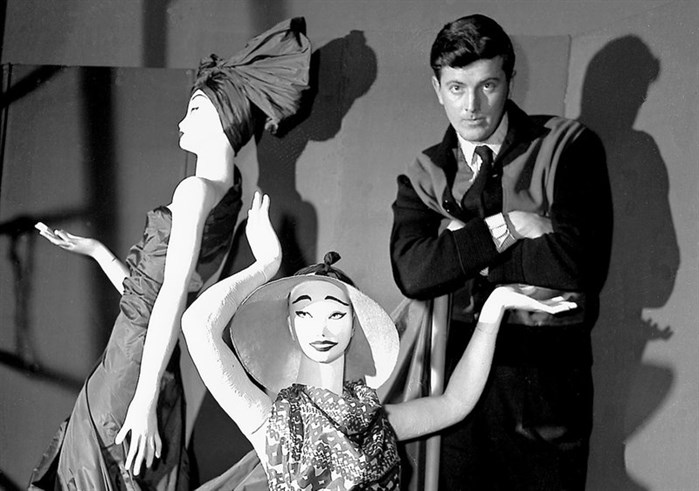 In this Feb. 1, 1952 file photo, French fashion designer Hubert de Givenchy poses with mannequins in his shop in Paris.