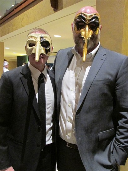Doug Tumber, left, and Mike Krueger, wear their rendition of a phantom masquerade mask at the JCI Gala and Charity Auction April 21 at the Vernon Lodge. 