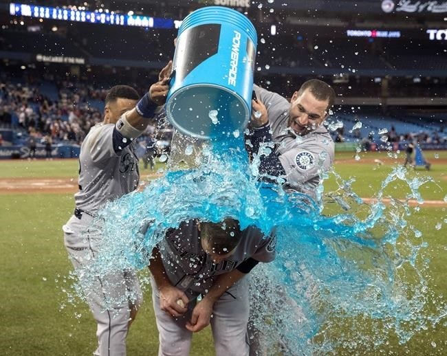 Seattle Mariners starting pitcher James Paxton, from Ladner, B.C., is hit with gatorade by teammates Robinson Cano and Mike Zunino after he pitched a no-hitter against the Toronto Blue Jays in American League MLB baseball actionin Toronto on Tuesday May 8, 2018. Paxton is the first Canadian to have a no-hitter since Toronto's Dick Fowler did it for the Philadelphia Athletics in 1945.