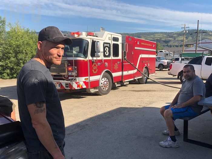 KAMLOOPS B.C. - Kenny Girous poses in front of one of four fire trucks that came to fight the blaze set off in a wood dryer on May 28, 2018.