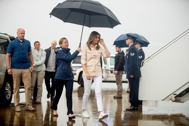 First lady Melania Trump, accompanied by chief of staff Lindsay Reynolds, center left, walks across the tarmac before boarding a plane at McAllen Miller International Airport in McAllen, Texas, Thursday, June 21, 2018, after visiting the Upbring New Hope Children Center run by the Lutheran Social Services of the South.