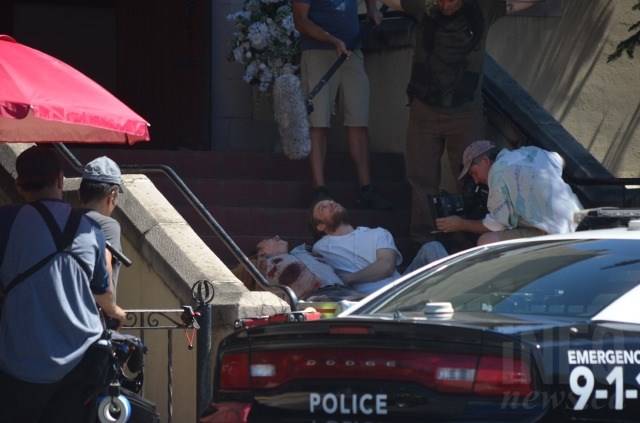 Nicolas Cage lies on the steps of the All Saints Anglican Church in Vernon while shooting a movie, Thursday, July 12, 2018.