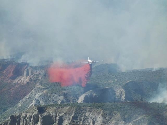 Fire retardant is dropped along the perimeter of the Shuswap Road fire on July 12, 2018.