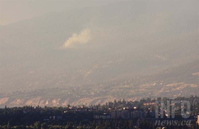 Smoke can be seen rising north of Penticton, through the smoke haze already forming, from a wildfire above Naramata, Tuesday, July 17, 2018.