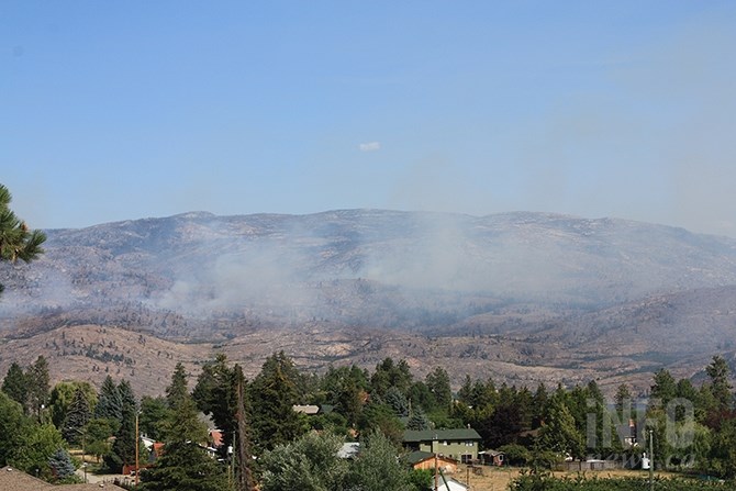 The Law Creek fire in Okanagan Mountain Park this afternoon, July 24, 2018, was producing more smoke than the Mount Eneas fire. The Law Creek fire is burning in crags and crevices in Okanagan Mountain Park and has not moved closer to Kelowna in five days.