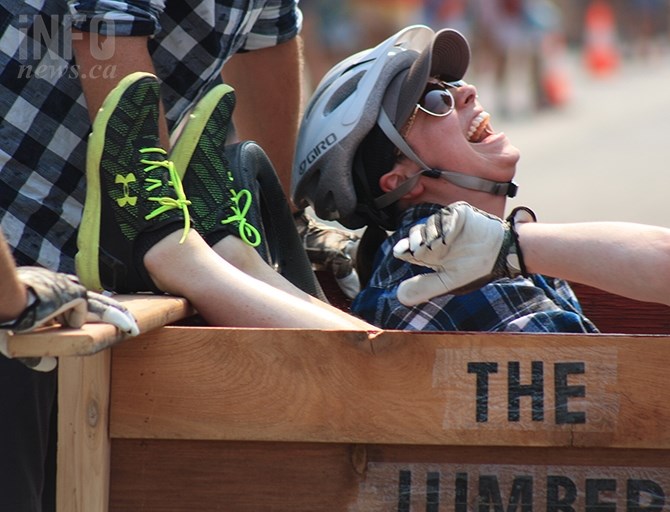 Contestent Dayna Pedro of BP Wood's team the Lumber Rumblers enjoys a laugh during the Peach Bin Race in Penticton, Wednesday, Aug. 8, 2018.