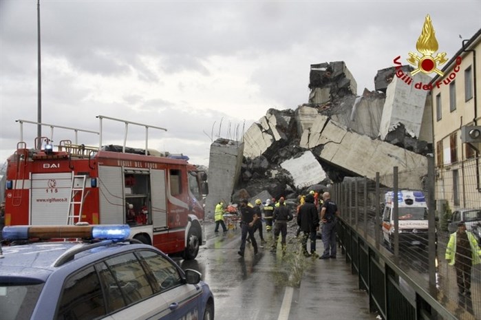 In this photo released by the Italian firefighters, rescuers work among the rubble of the collapsed Morandi highway bridge in Genoa, northern Italy, Tuesday, Aug. 14, 2018. A large section of the bridge collapsed over an industrial area in the Italian city of Genova during a sudden and violent storm, leaving vehicles crushed in rubble below.
