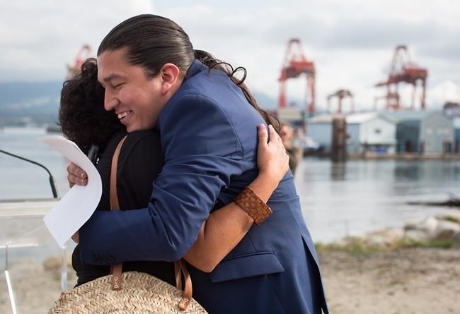 Khelsilem (Dustin Rivers), right, elected councillor and spokesperson for Squamish Nation, embraces Tsleil-Waututh Nation councillor Charlene Aleck in celebration before First Nations leaders respond to a Federal Court of Appeal ruling on the Kinder Morgan Trans Mountain Pipeline expansion, during a news conference in Vancouver, on Thursday August 30, 2018.