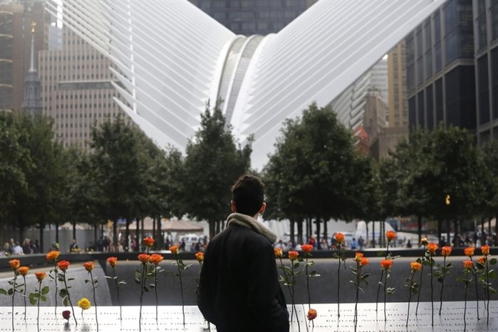 A man looks at the North Pool at the World Trade Center during a ceremony marking the 17th anniversary of the terrorist attacks on the United States. Tuesday, Sept. 11, 2018, in New York. In the background is the World Trade Center Transportation Hub.