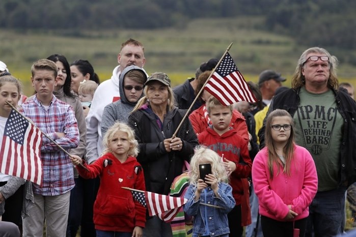 Audience members attend the September 11th Flight 93 Memorial Service, Tuesday, Sept. 11, 2018, in Shanksville, Pa. President Donald Trump is marking 17 years since the worst terrorist attack on U.S. soil by visiting the Pennsylvania field that became a Sept. 11 memorial.