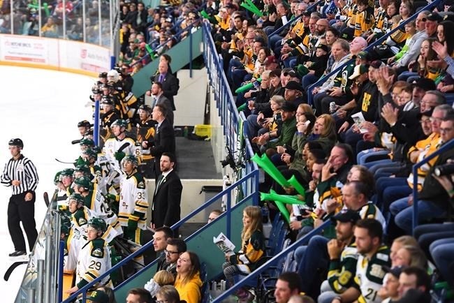 Humboldt Broncos players, new coach Nathan Oystrick and fans look on during second period SJHL hockey action against the Nipawin Hawks in Humbolt, Sask., on Wednesday, Sept. 12, 2018.