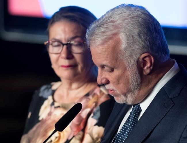 Quebec Liberal Leader Philippe Couillard looks down at his speech as he speaks to supporters after he lost the general election to a majority CAQ government, Monday, October 1, 2018 in Saint-Felicien, Quebec. Couillard's wife Suzanne Pilote looks on.